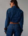 Cropped denim jacket. Collar neckline. Long sleeves with button closures. Front button closures. Unlined.