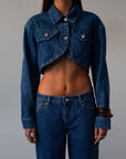 Cropped denim jacket. Collar neckline. Long sleeves with button closures. Front button closures. Unlined.
