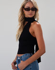 Ribbed knit cropped tank. Asymmetric neckline with adjustable halter tie. Unlined. black tank. fall outfit. fall top. going out top
