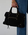 black Suede bag. Adjustable/detachable strap. Fixed top handles. Top zipper closure. Front zipper pocket. Fully lined. Inner pockets and zipper pocket.