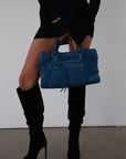 blue Suede bag. Adjustable/detachable strap. Fixed top handles. Top zipper closure. Front zipper pocket. Fully lined. Inner pockets and zipper pocket.