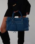 blue Suede bag. Adjustable/detachable strap. Fixed top handles. Top zipper closure. Front zipper pocket. Fully lined. Inner pockets and zipper pocket.