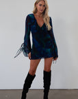Printed chiffon dress. Long sleeves with tie closures. Ruffle trim. Front and back tie closures. Side zipper closure. Fully lined. mini dress. blue and green mini dress. fall outfit