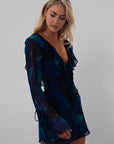 Printed chiffon dress. Long sleeves with tie closures. Ruffle trim. Front and back tie closures. Side zipper closure. Fully lined. mini dress. blue and green mini dress. fall outfit