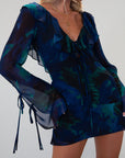 Printed chiffon dress. Long sleeves with tie closures. Ruffle trim. Front and back tie closures. Side zipper closure. Fully lined. mini dress. blue and green mini dress. fall outfit