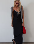 Polka dot satin maxi dress. Adjustable straps. Front tie closure. Unlined. black and white polka dot maxi dress. fall transition dress. black maxi dress