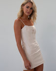 Seamed denim dress. Adjustable straps. Back zipper closure. Fully lined. cream mini dress. fall outfit