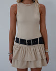 Knit sleeveless dress. Tiered skirt. Adjustable/detachable vegan leather belt. Back hook and eye and zipper closures. Fully lined.