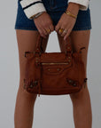 Genuine leather bag. Adjustable/detachable strap. Fixed top handles. Top zipper closure. Front zipper pocket. Fully lined. Inner zipper pocket.