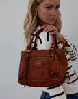 Genuine leather bag. Adjustable/detachable strap. Fixed top handles. Top zipper closure. Front zipper pocket. Fully lined. Inner zipper pocket.