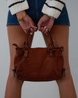Genuine leather bag. Adjustable/detachable strap. Fixed top handles. Top zipper closure. Front zipper pocket. Fully lined. Inner zipper pocket.