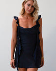 Satin dress. Adjustable straps with ruffle trim. Side hook and eye and zipper closures. Elastic back strap with clasp closure. Fully lined. navy blue mini dress. holiday dress. mini holiday dress