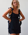 Satin dress. Adjustable straps with ruffle trim. Side hook and eye and zipper closures. Elastic back strap with clasp closure. Fully lined. navy blue mini dress. holiday dress. mini holiday dress