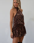 Animal printed chiffon dress. Adjustable halter neckline with tie closure. Side zipper closure. Elastic back. Fully lined.