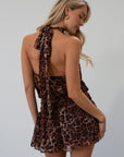 Animal printed chiffon dress. Adjustable halter neckline with tie closure. Side zipper closure. Elastic back. Fully lined.