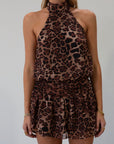 Animal printed chiffon dress. Adjustable halter neckline with tie closure. Side zipper closure. Elastic back. Fully lined.