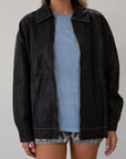 Vegan leather oversized jacket. Collar neckline. Snap button sleeve closures. Exposed front zipper closure. Front pockets with exposed zipper closures. Adjustable sides. Fully lined. 