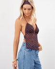Polka dot chiffon crop top. Adjustable halter neckline with tie closure. Adjustable back tie closures. Partially lined. Detachable self tie. brown and white polka dot halter top. going out top. open back top.
