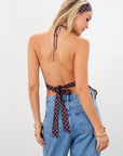 Polka dot chiffon crop top. Adjustable halter neckline with tie closure. Adjustable back tie closures. Partially lined. Detachable self tie. brown and white polka dot halter top. going out top. open back top.