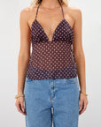 Polka dot chiffon crop top. Adjustable halter neckline with tie closure. Adjustable back tie closures. Partially lined. Detachable self tie. brown and white polka dot halter top. going out top. open back top.