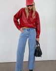 Red Vegan leather bomber jacket. Collar neckline. Snap button long sleeve closures. Front snap button down closures. Front pockets. Elastic hem. Fully lined. fall jacket. fall outfit