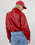 Red Vegan leather bomber jacket. Collar neckline. Snap button long sleeve closures. Front snap button down closures. Front pockets. Elastic hem. Fully lined. fall jacket. fall outfit