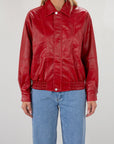Red Vegan leather bomber jacket. Collar neckline. Snap button long sleeve closures. Front snap button down closures. Front pockets. Elastic hem. Fully lined. fall jacket. fall outfit
