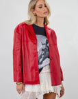 Vegan leather blazer. Single breast. Collar neckline. Front button down closure. Side pockets. Back slit. Fully lined. red leather blazer