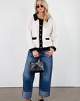 Colorblocked fuzzy crochet knit cardigan. Collar neckline. Front button down closure. Front pockets. Unlined. white cardigan. white and black cardigan. fall sweater. fall outfit. classy cardigan sweater. cardigan sweater