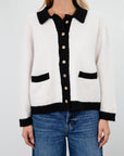 Colorblocked fuzzy crochet knit cardigan. Collar neckline. Front button down closure. Front pockets. Unlined. white cardigan. white and black cardigan. fall sweater. fall outfit. classy cardigan sweater. cardigan sweater