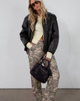 Camo printed cargo jeans. Side and back pockets. Button and zipper fly. Unlined.