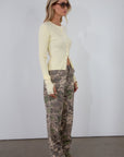 Camo printed cargo jeans. Side and back pockets. Button and zipper fly. Unlined.