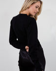 Black knit cardigan. Long sleeves. Front button down closure. Banded hems. Unlined. fall top. fall outfit. holiday outfit.