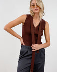 Ribbed knit sleeveless top. V-neckline. Front button down closure. Unlined. Neck tie. brown vest top. top with scarf. fall top.