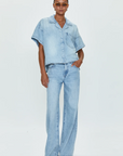 Low slung palazzo jeans. Button and zipper fly. Five pocket construction. Unlined. No stretch. baggy jeans. flare pant. light wash denim jeans
