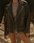 Faux leather jacket. Front zipper closure. Long sleeves either zipper closures. Front zipper pockets. Snap button closures. Fully lined. Brown leather jacket. brown oversized leather jacket. western outfit. ranch outfit
