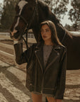 Faux leather jacket. Front zipper closure. Long sleeves either zipper closures. Front zipper pockets. Snap button closures. Fully lined. Brown leather jacket. brown oversized leather jacket. western outfit. ranch outfit