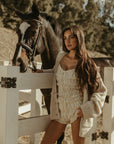 Smocked crop top. Short sleeves with elastic sleeve openings. Front tie closure. Fully lined. white smocked crop top.