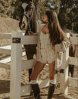 Smocked bloomer shorts. Elastic waistband with leg openings. Drawstring waist. Fully lined. white shorts. cream shorts
