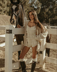 Smocked crop top. Short sleeves with elastic sleeve openings. Front tie closure. Fully lined. white smocked crop top.