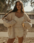 Smocked crop top. Short sleeves with elastic sleeve openings. Front tie closure. Fully lined. white smocked crop top.