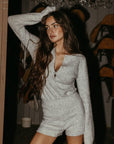 Fuzzy heather knit bodysuit. Long sleeves. Front button down closures. Snap bottom closures. Thong back. Fuzzy heather knit shorts. Unlined. grey knit set