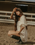 Floral printed woven dress. Elastic neckline. front tie closure. 3/4 sleeves with elastic openings. Unlined. floral mini dress. rumored mini dress. spring mini dress