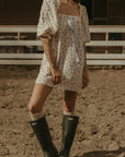 Floral printed woven dress. Elastic neckline. front tie closure. 3/4 sleeves with elastic openings. Unlined. floral mini dress. rumored mini dress. spring mini dress