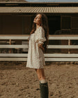 Floral printed woven dress. Elastic neckline. front tie closure. 3/4 sleeves with elastic openings. Unlined. floral mini dress. rumored mini dress. spring mini dress