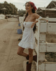 White Woven mini dress. Elastic straps. Inner rubber grip lining. Front tie closures. Crochet trim. Back hook and eye and zipper closures. Unlined. white sun dress