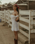 White Woven mini dress. Elastic straps. Inner rubber grip lining. Front tie closures. Crochet trim. Back hook and eye and zipper closures. Unlined. white sun dress