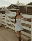 White Woven mini dress. Elastic straps. Inner rubber grip lining. Front tie closures. Crochet trim. Back hook and eye and zipper closures. Unlined. white sun dress
