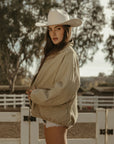 Denim jacket. Collar neckline. Long sleeves. Front zipper closure. Front pockets. Elastic sides. Fully lined. barn jacket. beige barn jacket. ranch shoot
