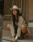 Denim jacket. Collar neckline. Long sleeves. Front zipper closure. Front pockets. Elastic sides. Fully lined. barn jacket. beige barn jacket. ranch shoot